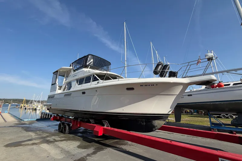  Yacht Photos Pics 1998 Carver 445 Aft Cabin Motor Yacht on red trailer at marina.