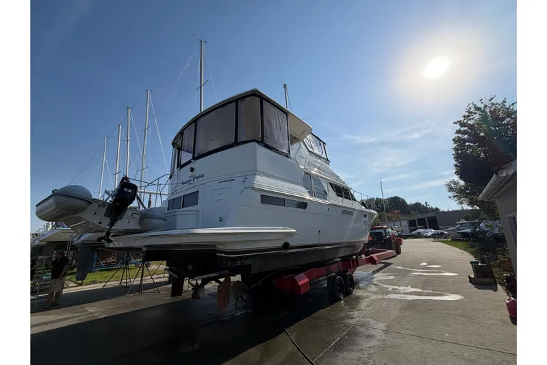  Yacht Photos Pics 1998 Carver 445 Aft Cabin Motor Yacht on trailer under sunny sky.