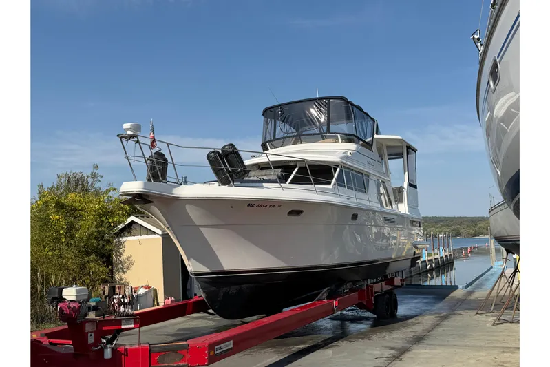  Yacht Photos Pics 1998 Carver 445 Aft Cabin Motor Yacht on trailer near water.