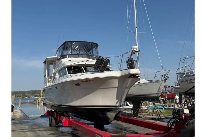  Yacht Photos Pics 1998 Carver 445 Aft Cabin Motor Yacht on trailer at marina, clear sky background.