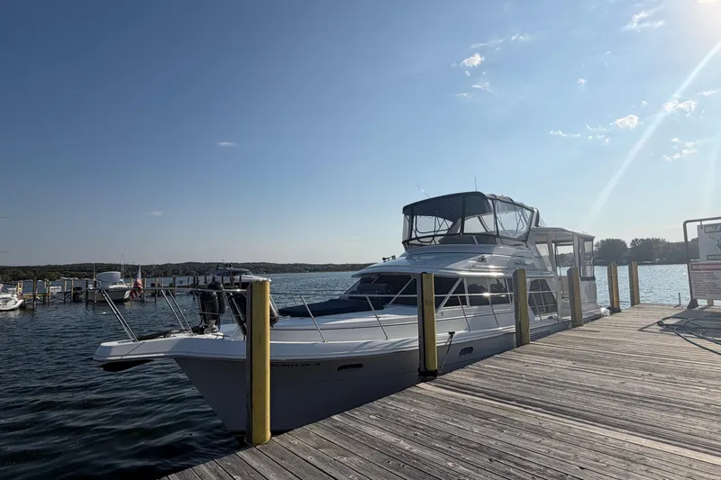  Yacht Photos Pics 1998 Carver 445 Aft Cabin Motor Yacht docked on a sunny day.