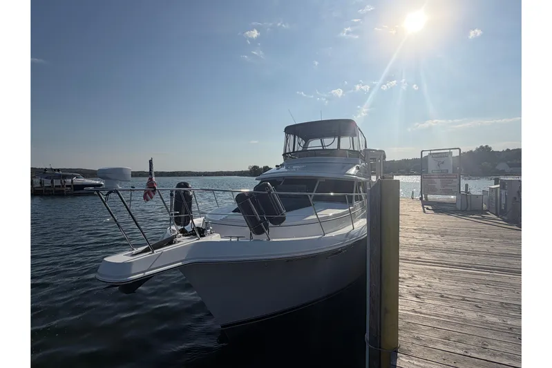  Yacht Photos Pics 1998 Carver 445 Aft Cabin Motor Yacht docked under sunny skies.