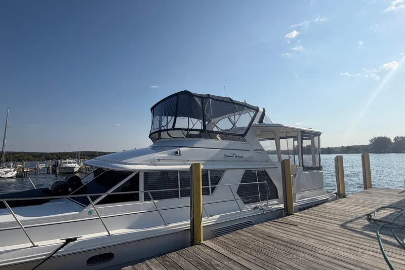  Yacht Photos Pics 1998 Carver 445 Aft Cabin Motor Yacht docked at a sunny marina.