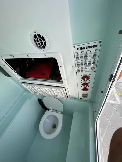  Yacht Photos Pics 2016 Contender 28 Sport boat interior with control panel and marine toilet.