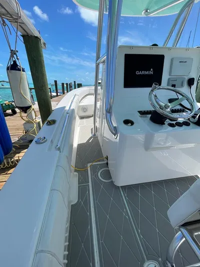  Yacht Photos Pics 2016 Contender 28 Sport boat with Garmin navigation, docked by clear blue water.