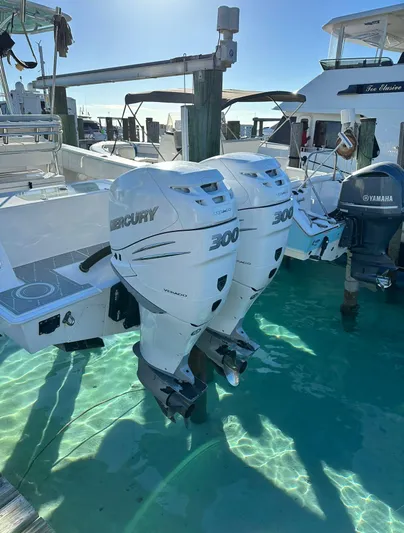  Yacht Photos Pics 2016 Contender 28 Sport boat with twin Mercury 300 outboard engines docked in clear water.