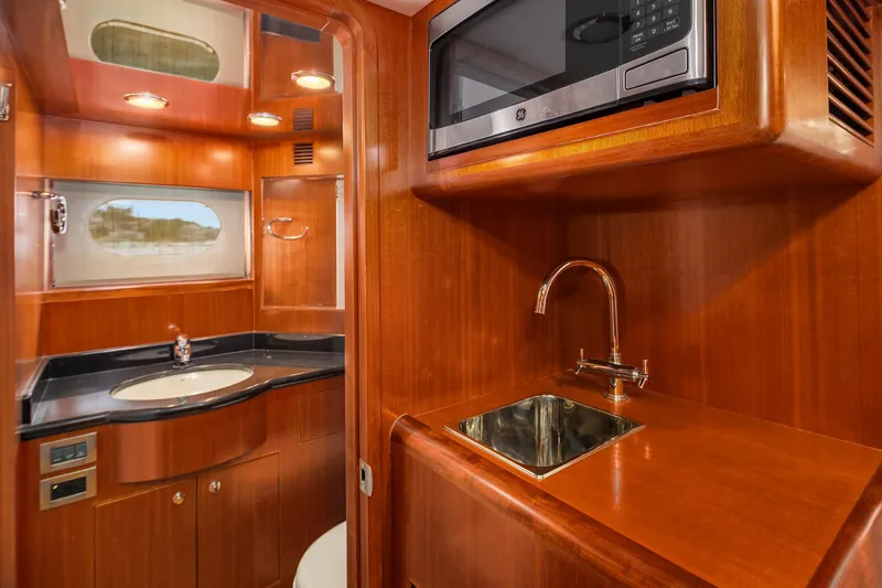 Coconut Yacht Photos Pics Luxurious wood-finished kitchenette and bathroom in 2009 Ocean Alexander 74 Flybridge Motoryacht.