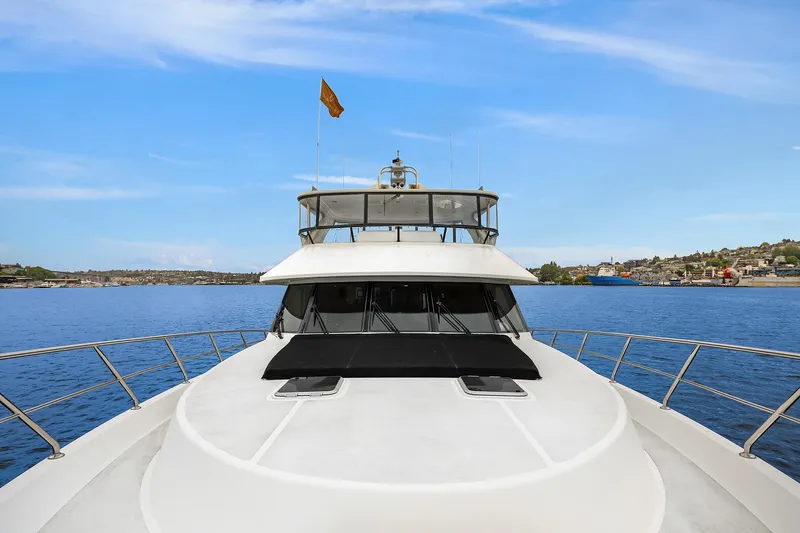 Coconut Yacht Photos Pics 2009 Ocean Alexander 74 Flybridge Motoryacht on calm water, clear sky background.