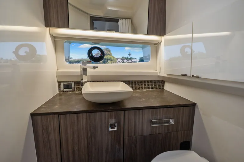  Yacht Photos Pics Luxurious bathroom interior of 2020 Sea Ray 400 SLX Outboard yacht with modern sink and window view.
