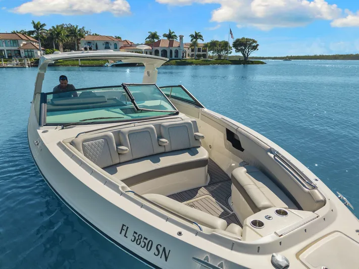  Yacht Photos Pics 2020 Sea Ray 400 SLX Outboard cruising on a sunny day near waterfront homes.