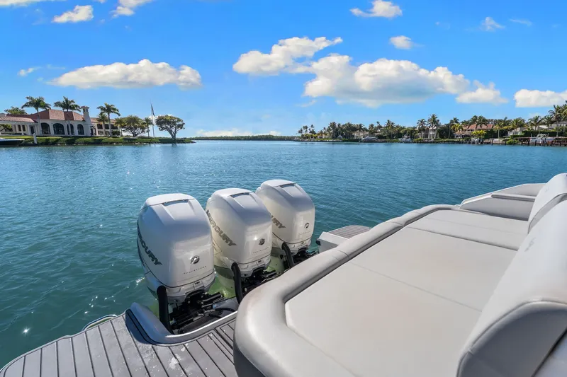  Yacht Photos Pics 2020 Sea Ray 400 SLX Outboard on serene water with luxury homes in the background.