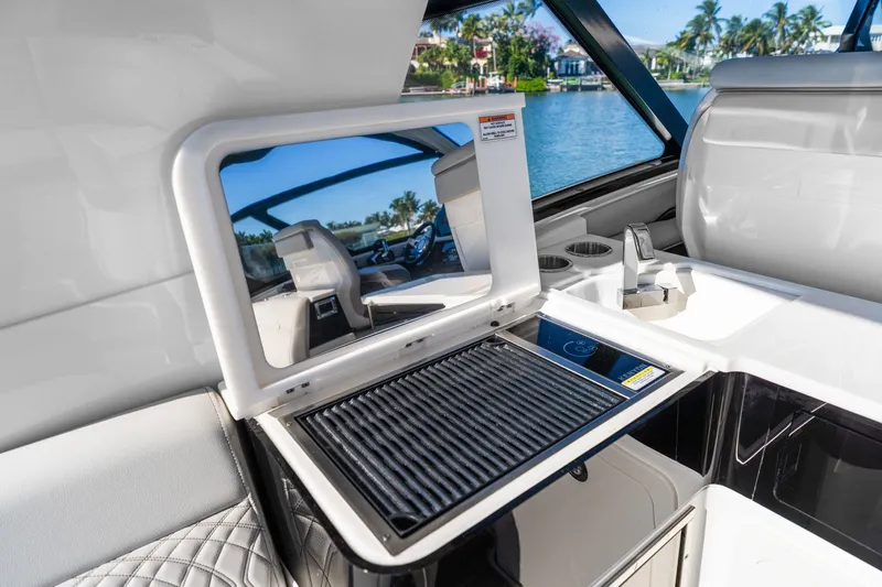  Yacht Photos Pics 2020 Sea Ray 400 SLX Outboard interior with grill and sink, overlooking water.