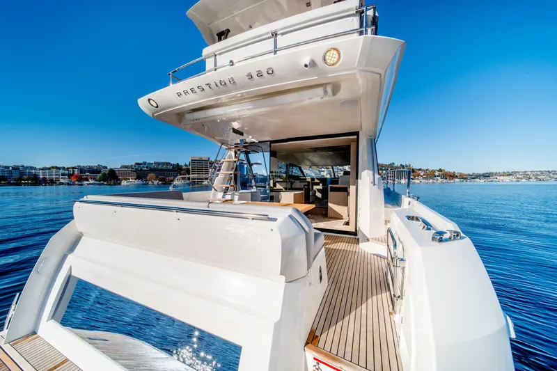  Yacht Photos Pics Luxurious 2023 Prestige 520 yacht on serene blue waters, showcasing sleek design and spacious deck.