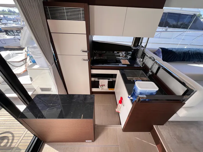 Yacht Photos Pics Modern kitchen interior on 2023 Prestige 520 yacht, featuring sleek cabinetry and appliances.