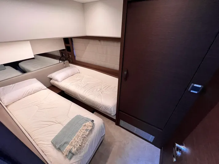  Yacht Photos Pics 2023 Prestige 520 yacht cabin with twin beds and modern decor.