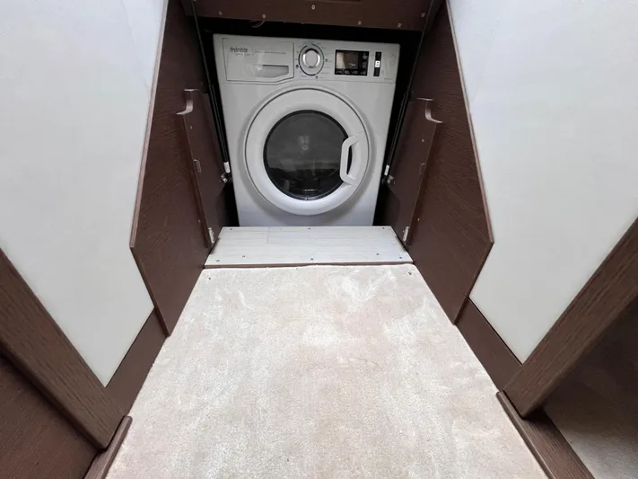 Yacht Photos Pics Laundry area with a modern washing machine in a 2023 Prestige 520 model.