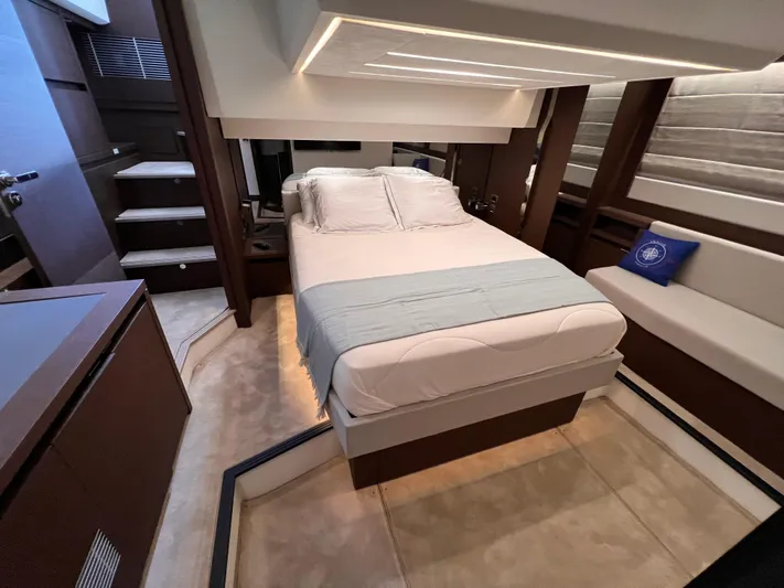  Yacht Photos Pics Luxurious bedroom interior of 2023 Prestige 520 yacht with modern design and cozy bedding.