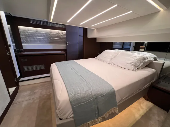  Yacht Photos Pics Luxurious bedroom interior of 2023 Prestige 520 yacht with modern design and ambient lighting.