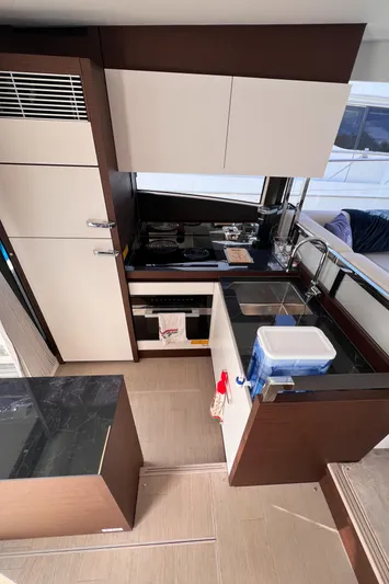  Yacht Photos Pics Modern kitchen interior on 2023 Prestige 520 yacht, featuring sleek cabinetry and appliances.