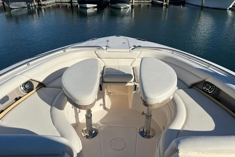  Yacht Photos Pics 2015 Grady-White Freedom 375 boat interior with plush seating and table, docked in marina.