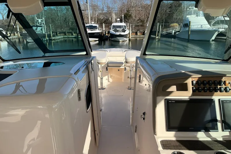  Yacht Photos Pics 2015 Grady-White Freedom 375 boat interior with dashboard and marina view.