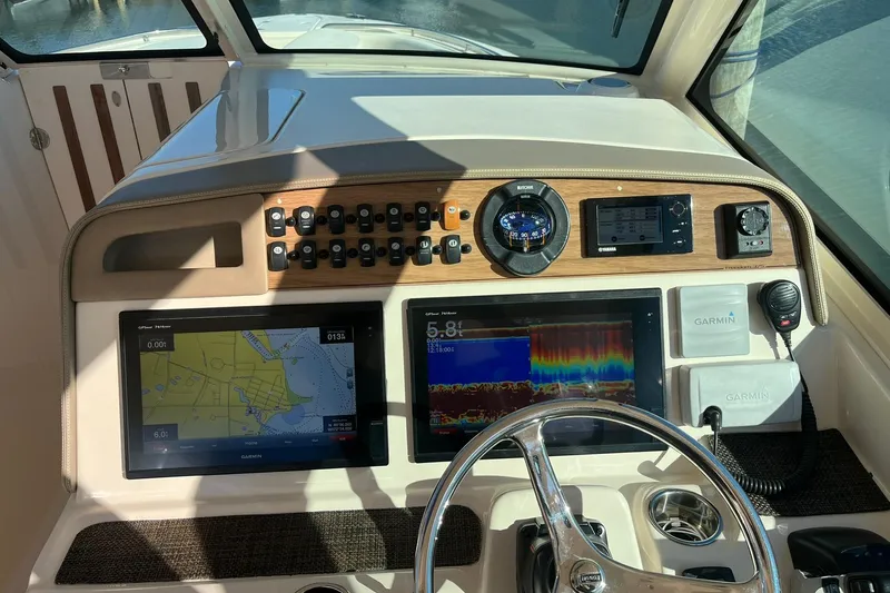  Yacht Photos Pics 2015 Grady-White Freedom 375 boat dashboard with Garmin navigation displays and controls.