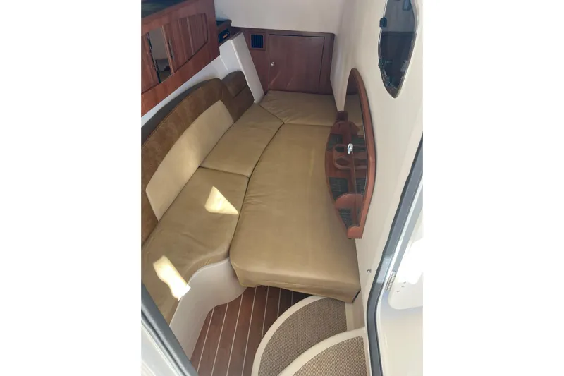  Yacht Photos Pics Interior cabin of 2015 Grady-White Freedom 375 boat with beige seating and wooden accents.