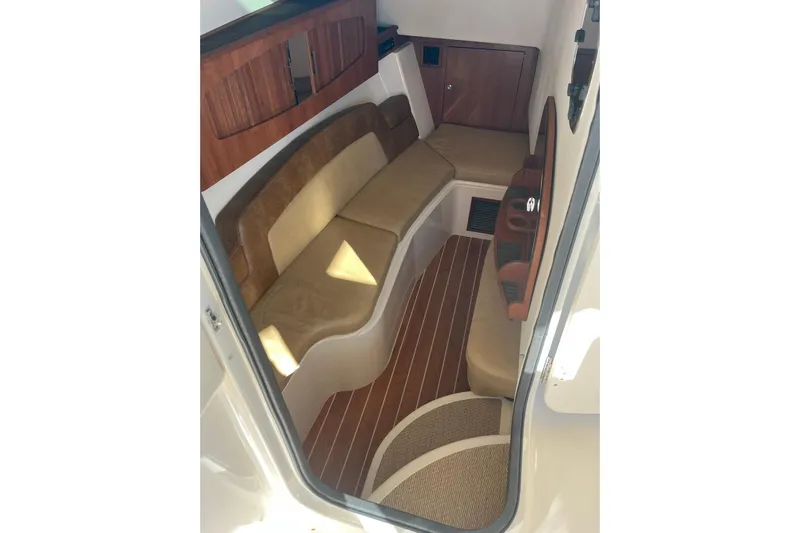  Yacht Photos Pics 2015 Grady-White Freedom 375 cabin interior with cushioned seating and wood accents.