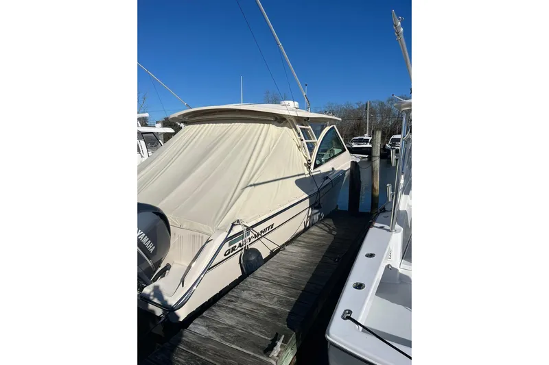 Yacht Photos Pics 2015 Grady-White Freedom 375 boat docked with cover, clear blue sky.