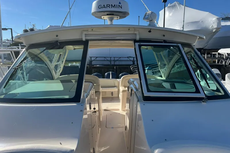  Yacht Photos Pics 2015 Grady-White Freedom 375 boat with Garmin radar, docked under clear skies.