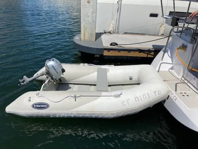 Nina Mia Yacht Photos Pics Inflatable dinghy with motor docked beside a 2018 Catalina 385 sailboat.