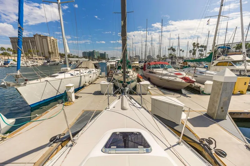 Nina Mia Yacht Photos Pics Marina view with 2018 Catalina 385 sailboat docked among other boats.