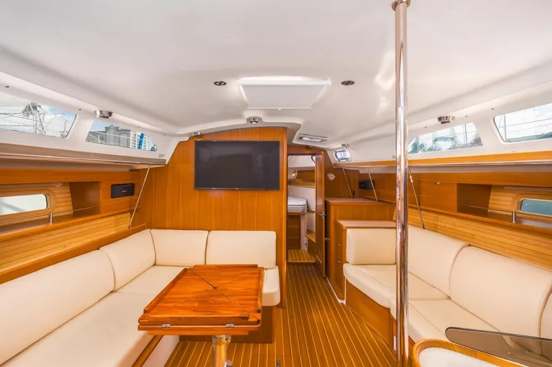 Nina Mia Yacht Photos Pics Luxurious interior of 2018 Catalina 385 yacht with wood finish and comfortable seating.