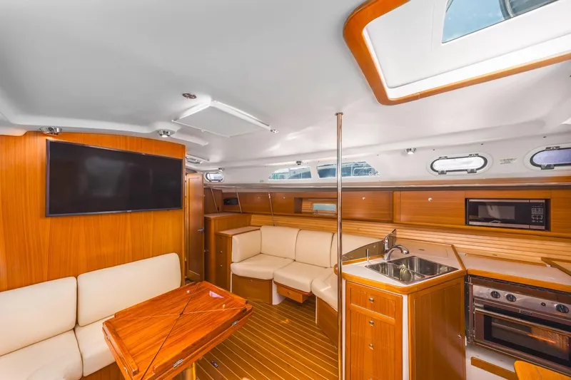 Nina Mia Yacht Photos Pics Luxurious interior of 2018 Catalina 385 yacht with modern kitchen and seating area.