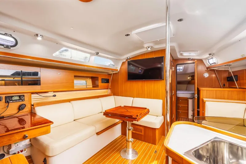 Nina Mia Yacht Photos Pics Luxurious interior of 2018 Catalina 385 sailboat with modern amenities and elegant wood finish.