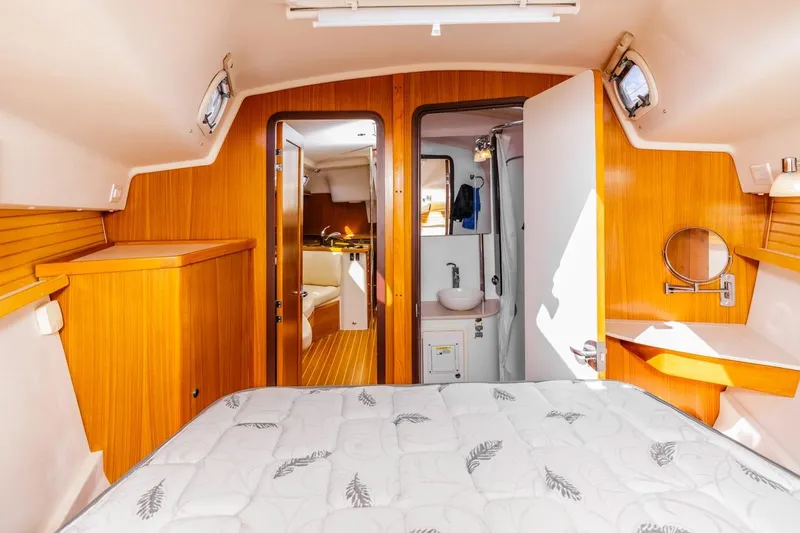 Nina Mia Yacht Photos Pics Interior of 2018 Catalina 385 sailboat, featuring cozy cabin with wood paneling and compact bathroom.