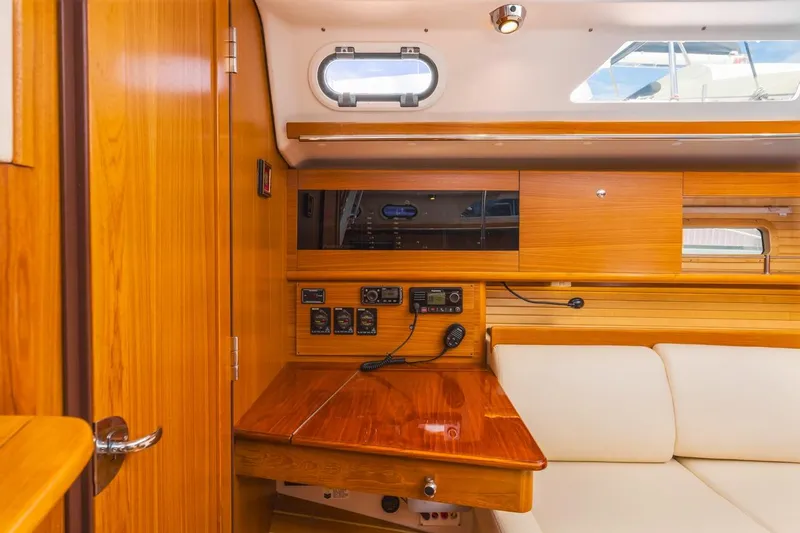 Nina Mia Yacht Photos Pics Interior of 2018 Catalina 385 yacht with wooden cabinetry and navigation controls.