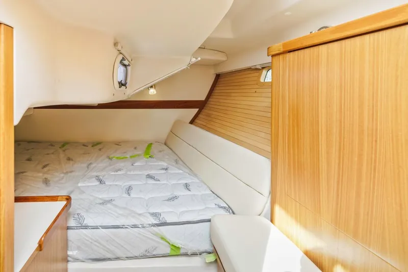 Nina Mia Yacht Photos Pics 2018 Catalina 385 yacht interior cabin with cozy bed and wooden paneling.