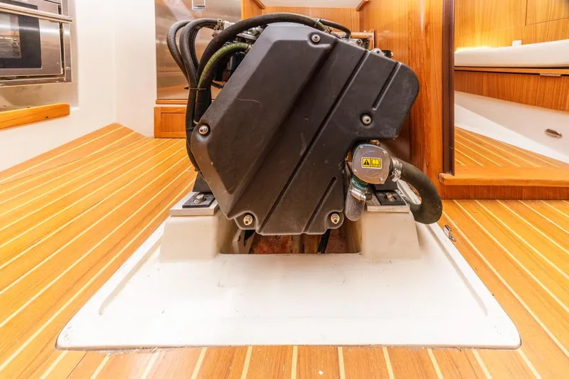 Nina Mia Yacht Photos Pics Engine compartment of a 2018 Catalina 385 sailboat with wooden flooring.