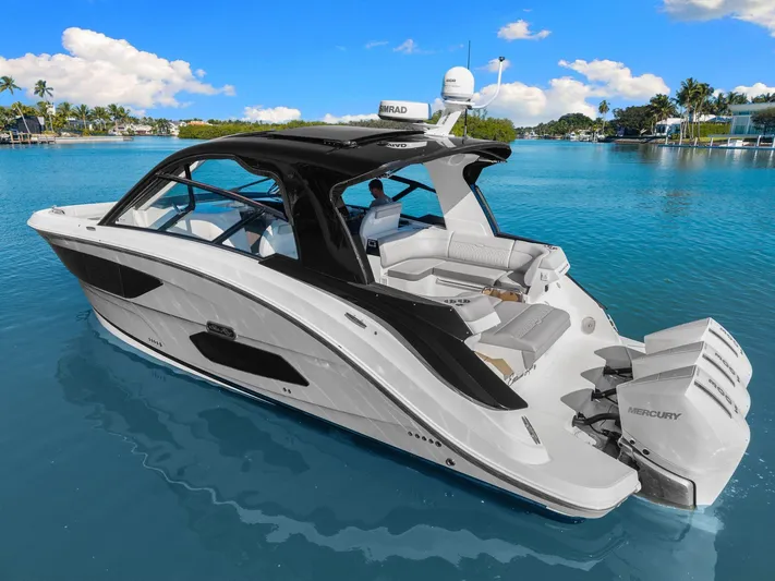  Yacht Photos Pics 2023 Sea Ray 370 Sundancer luxury boat on clear blue water, showcasing sleek design and powerful engines.