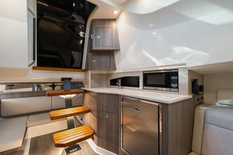  Yacht Photos Pics Interior of 2023 Sea Ray 370 Sundancer yacht with modern kitchen and seating area.