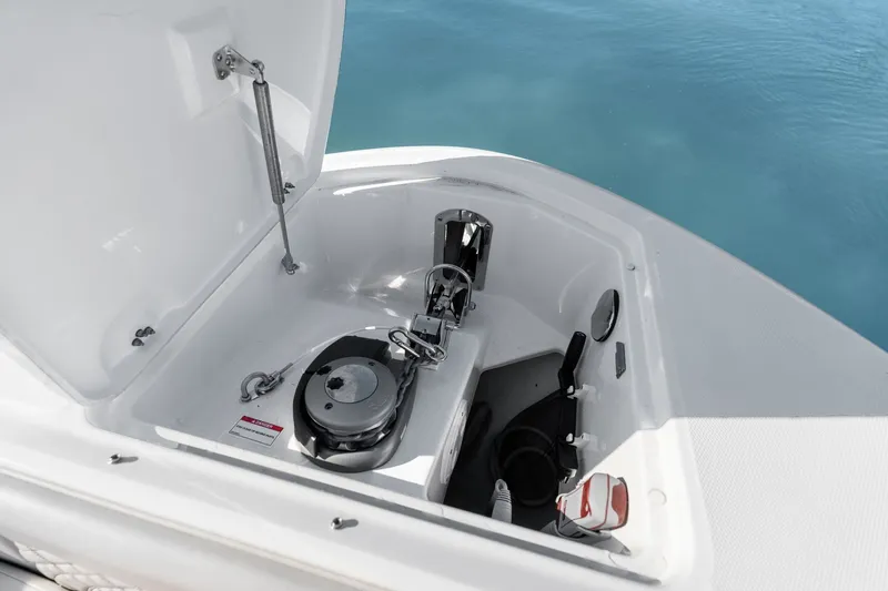  Yacht Photos Pics Open anchor compartment on 2023 Sea Ray 370 Sundancer, showcasing marine equipment and storage.