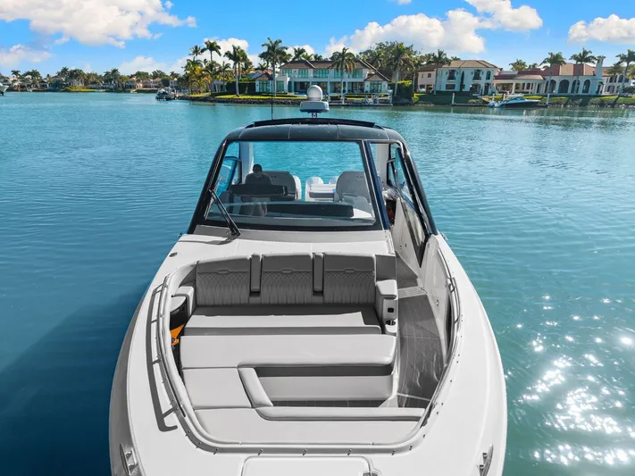  Yacht Photos Pics 2023 Sea Ray 370 Sundancer boat on tranquil water with luxury waterfront homes.