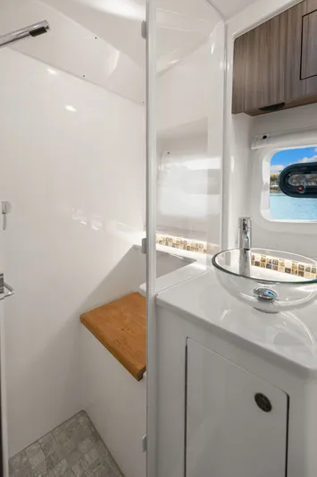  Yacht Photos Pics 2023 Sea Ray 370 Sundancer bathroom with modern sink and window view.