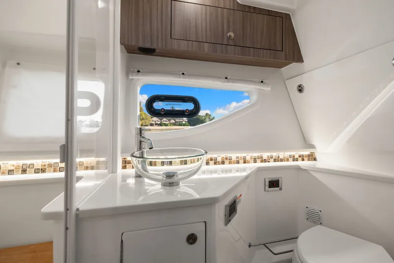  Yacht Photos Pics Luxurious bathroom interior of 2023 Sea Ray 370 Sundancer yacht with modern fixtures.