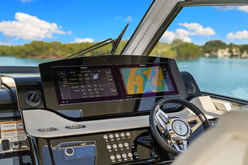  Yacht Photos Pics 2023 Sea Ray 370 Sundancer helm with advanced navigation display and scenic water view.