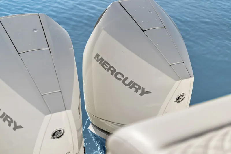  Yacht Photos Pics Twin Mercury outboard engines on a 2023 Sea Ray 370 Sundancer, floating on calm water.