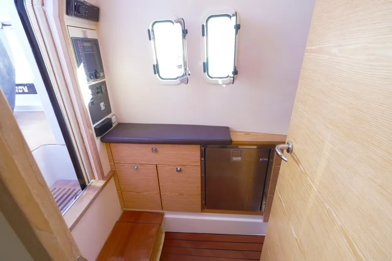  Yacht Photos Pics Interior of 2018 Fjord 36 Xpress yacht with wooden cabinetry and small window.