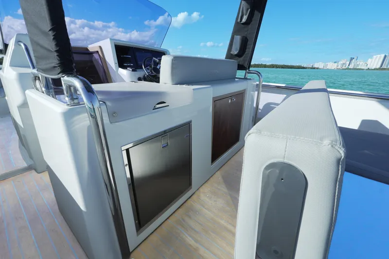  Yacht Photos Pics 2018 Fjord 36 Xpress boat interior with modern helm and seating, overlooking blue waters.