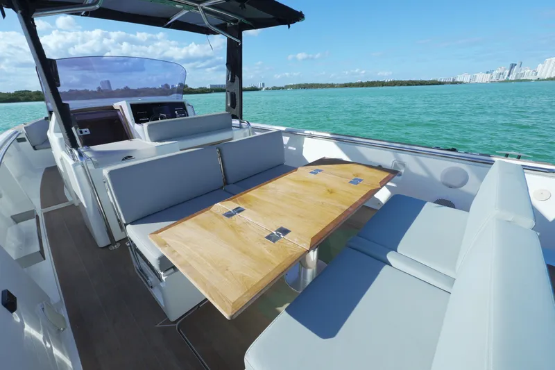  Yacht Photos Pics 2018 Fjord 36 Xpress boat interior with seating and wooden table on open water.
